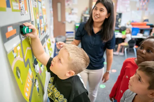 A Junior Achievement Volunteer teaches students